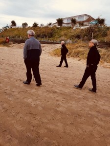 Elderly-men-walking-on-beach